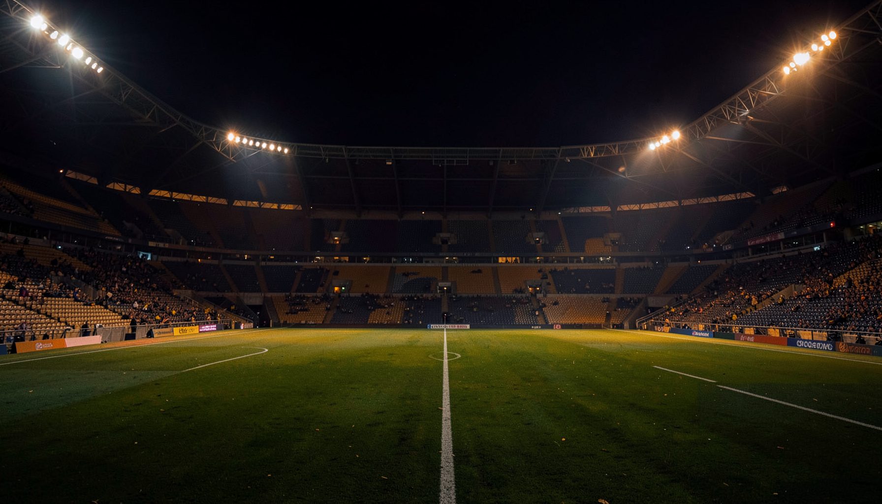 Dark navy and amber stadium atmosphere with empty stands under floodlights, deep shadows and warm glow across the pitch